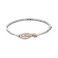 Silver bangle bracelet with rose gold detail and gemstones.
