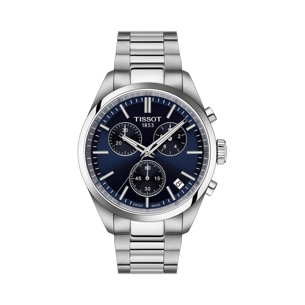 Close-up of the Tissot PR100 chronograph watch, showcasing the blue dial, stainless steel bracelet, and date window. Tissot