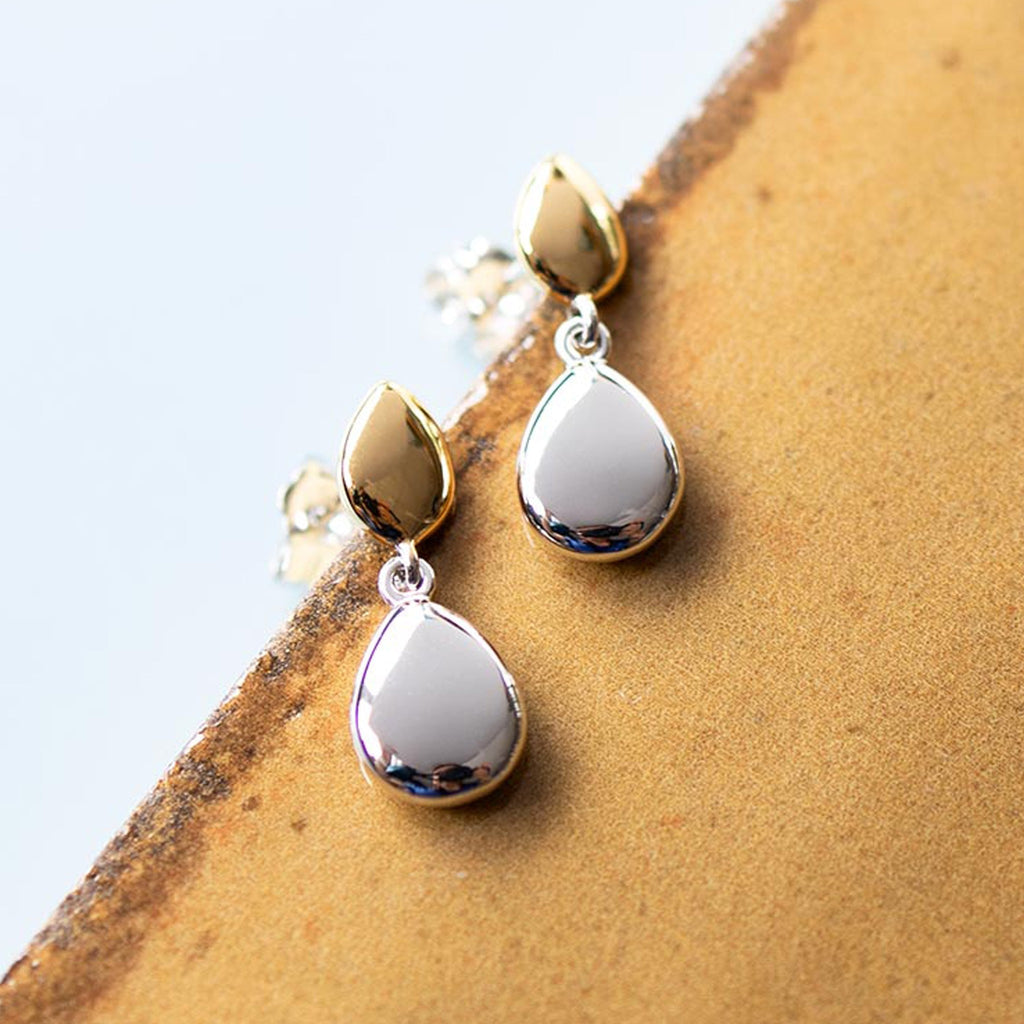 Elegant silver droplet earrings from Kit Heath's Golden Coast collection, detailed pebble stud design. Close-up product