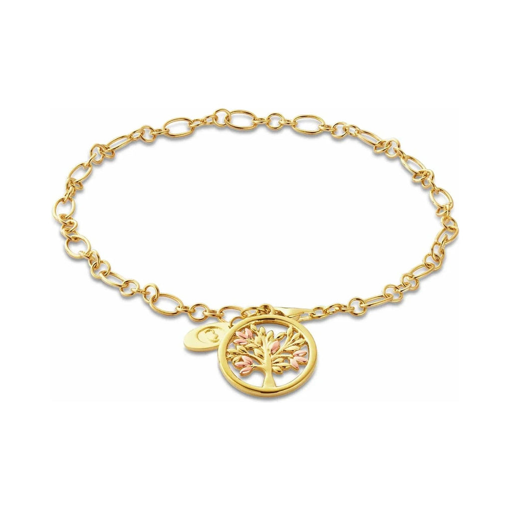 Gold chain link bracelet with gold tree charm.