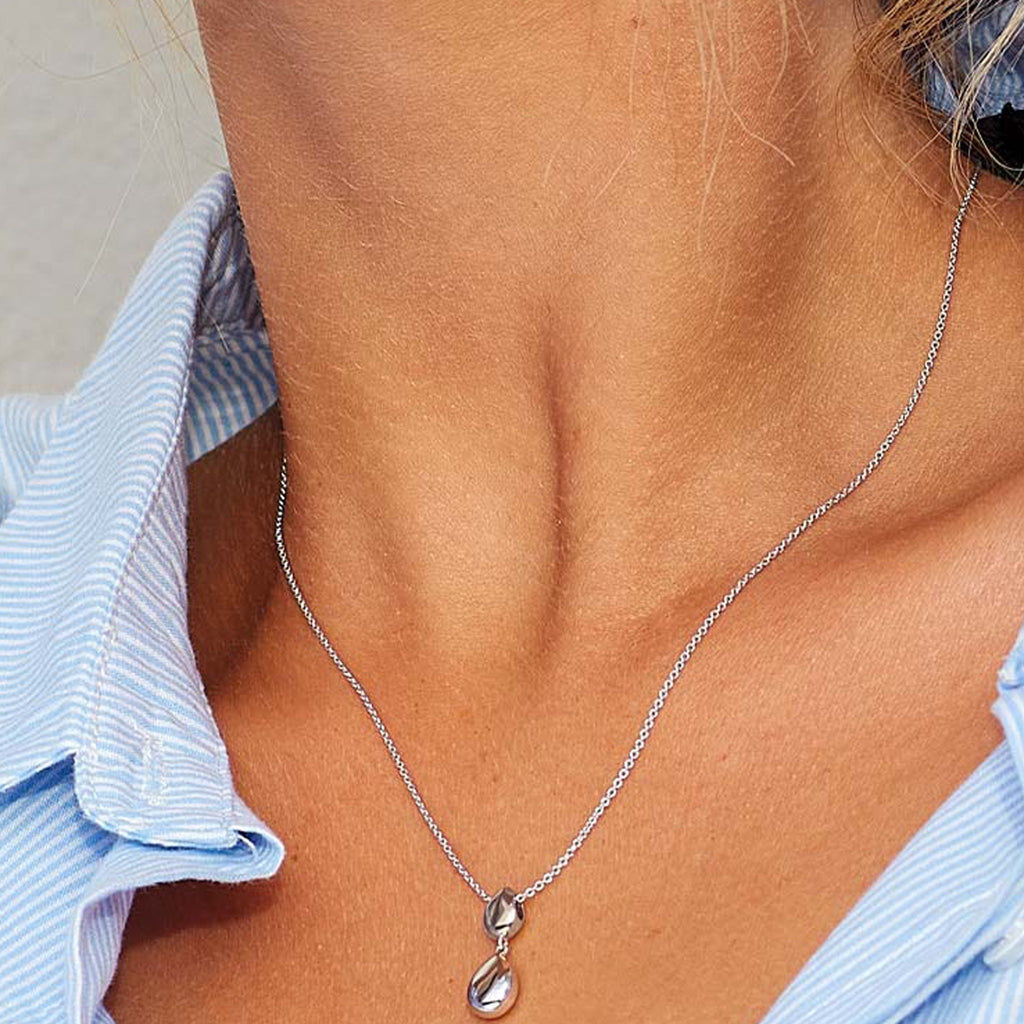 The Kit Heath Coast Pebble Double Droplet Necklace, a silver necklace from Kit Heath, available at OD’s Jewellers in St Helens.