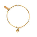 Gold and silver beaded bracelet with moon and sun charm.
