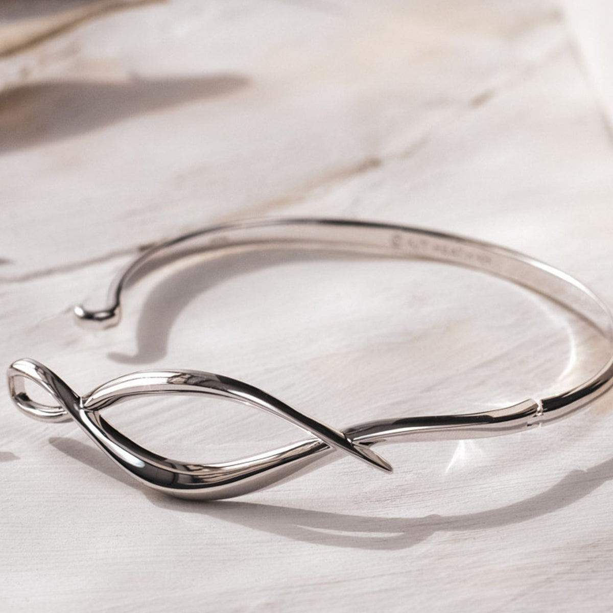 The Kit Heath Entwine Twine Twist Hinged Bangle, a silver bracelet from Kit Heath, available at OD’s Jewellers in St Helens.