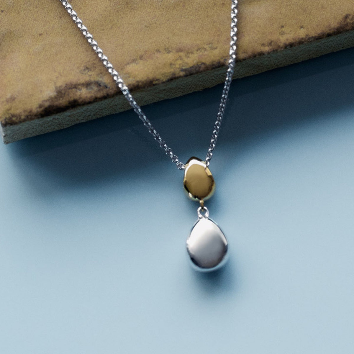 The Kit Heath Coast Pebble Golden Double Droplet Necklace, a gold plated necklace from Kit Heath, available at OD’s Jewellers in St Helens.