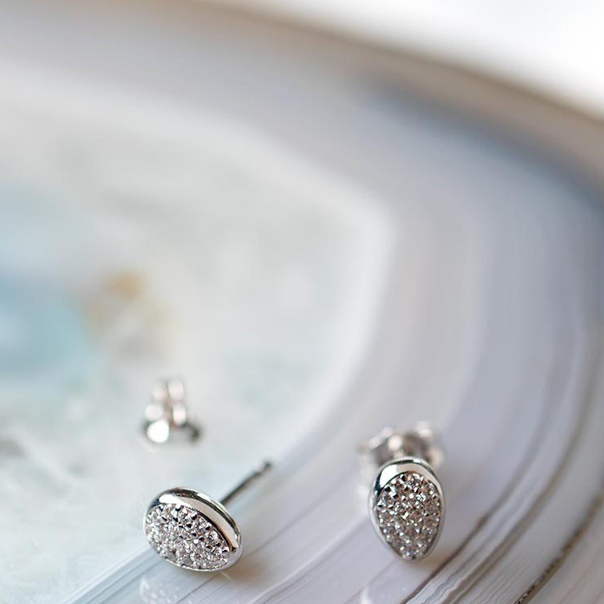 Silver stud earrings featuring pave CZ detail, highlighting the Glisten design of the Kit Heath Coast Pebble collection.