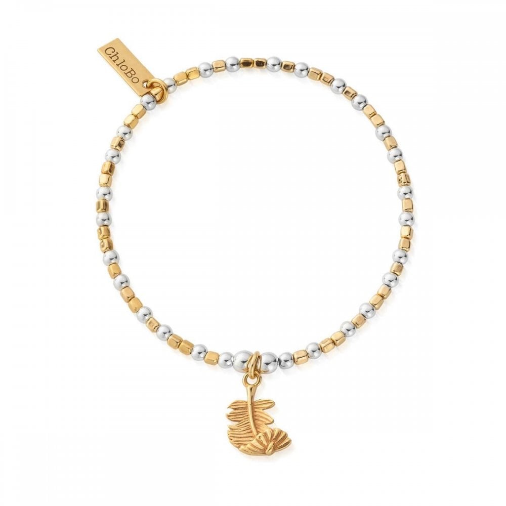 ChloBo bracelet with alternating silver & gold beads, charm with feathers. Elegant, layered wristwear.