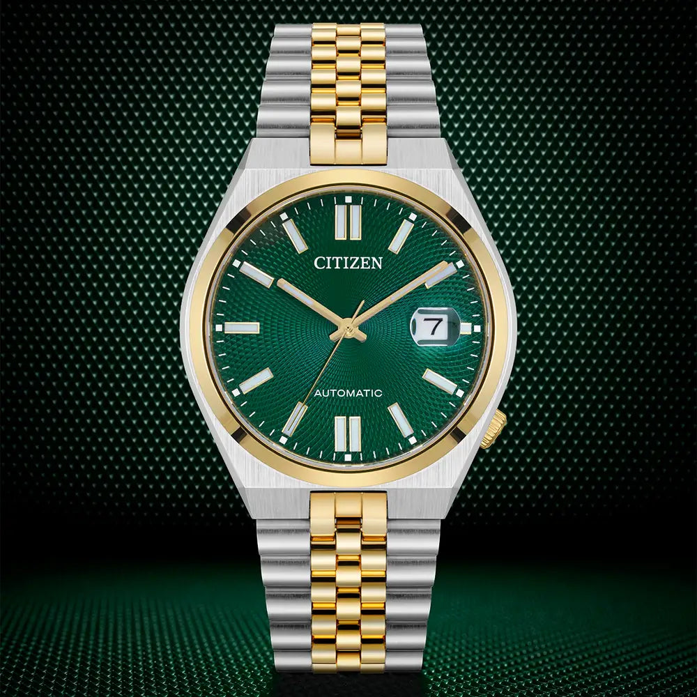 Close-up of a two-tone Citizen automatic watch with a green dial.