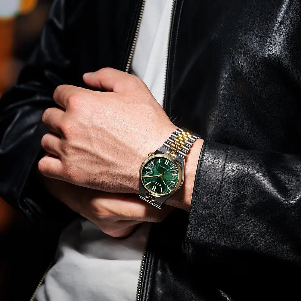 Man wearing a gold and silver watch, black leather jacket, and white shirt.
