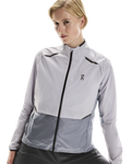 Woman wearing a light lilac jacket with black accents on a white background