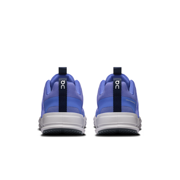 Blue athletic shoes with white soles on a white background