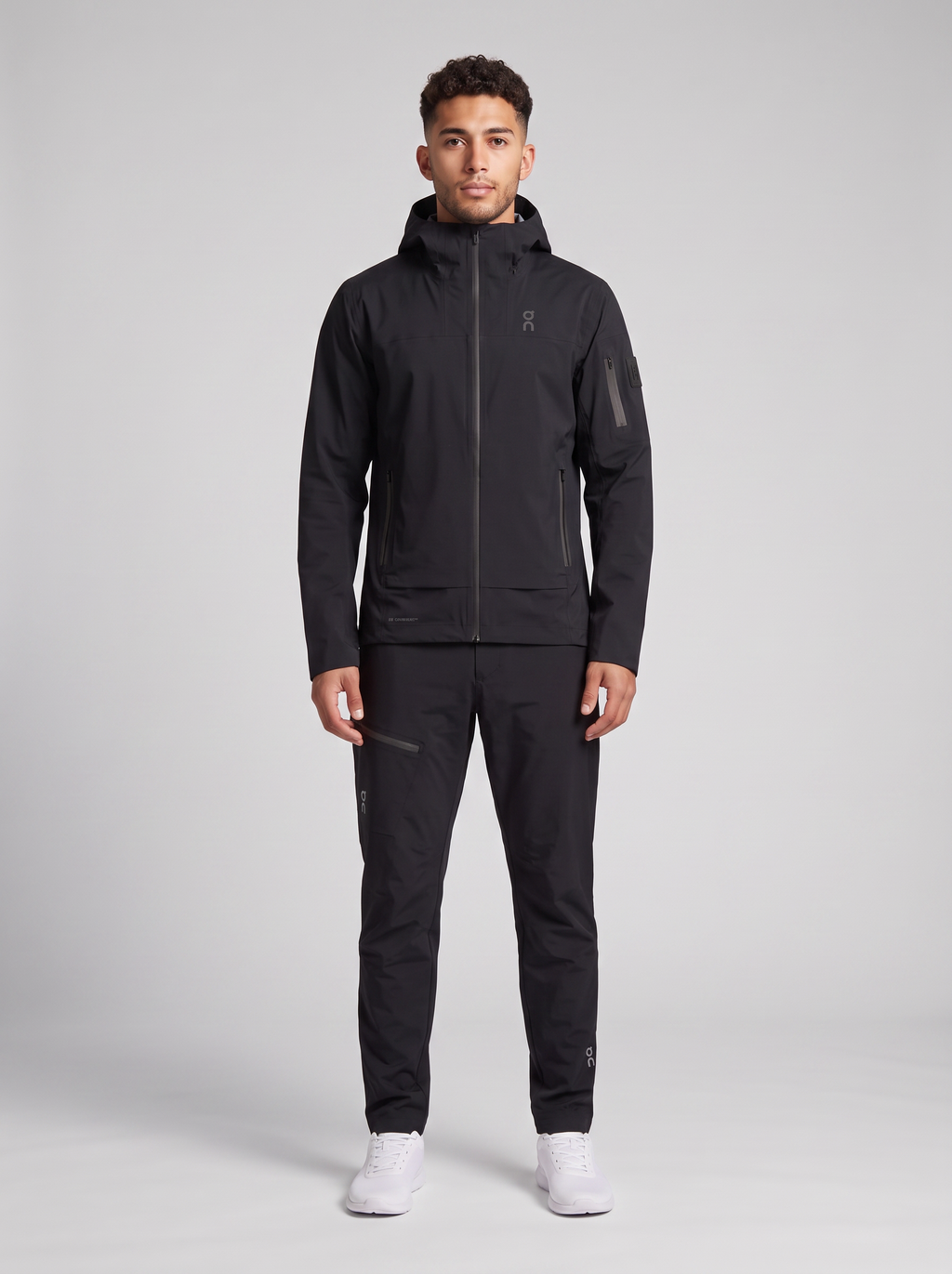 Men's On Running Black Trek Waterproof Jacket & Water Resistant Trek Pants Set — on model