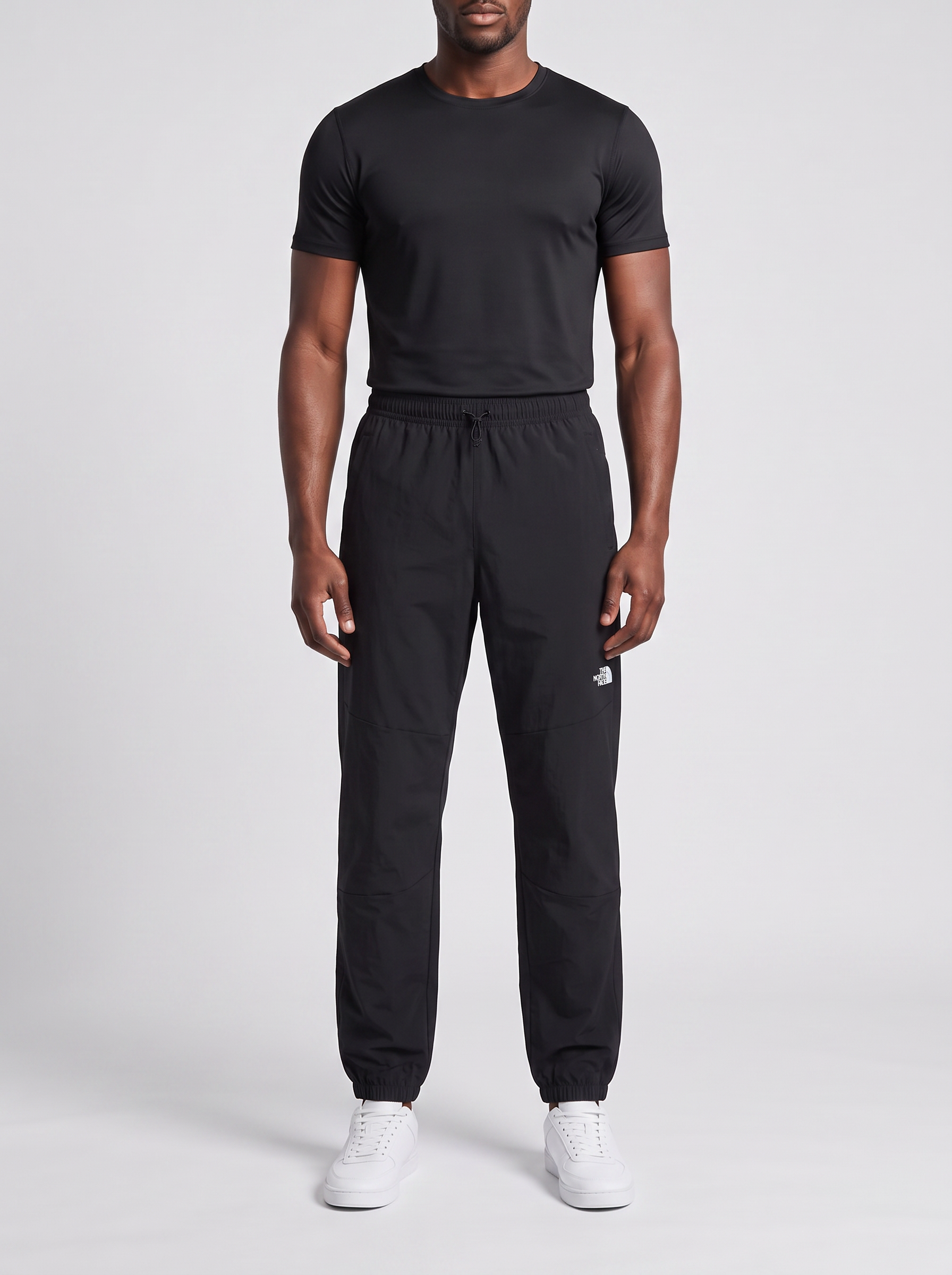 Men's The North Face Black Mountain Athletics Wind Pant — on model