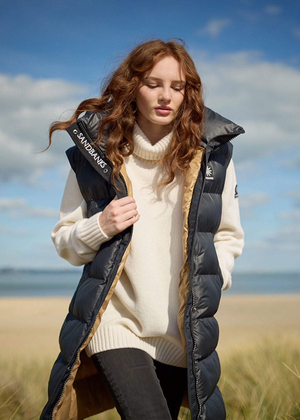 model wearing Sandbanks Black Long Shell Bay Hooded Gilet