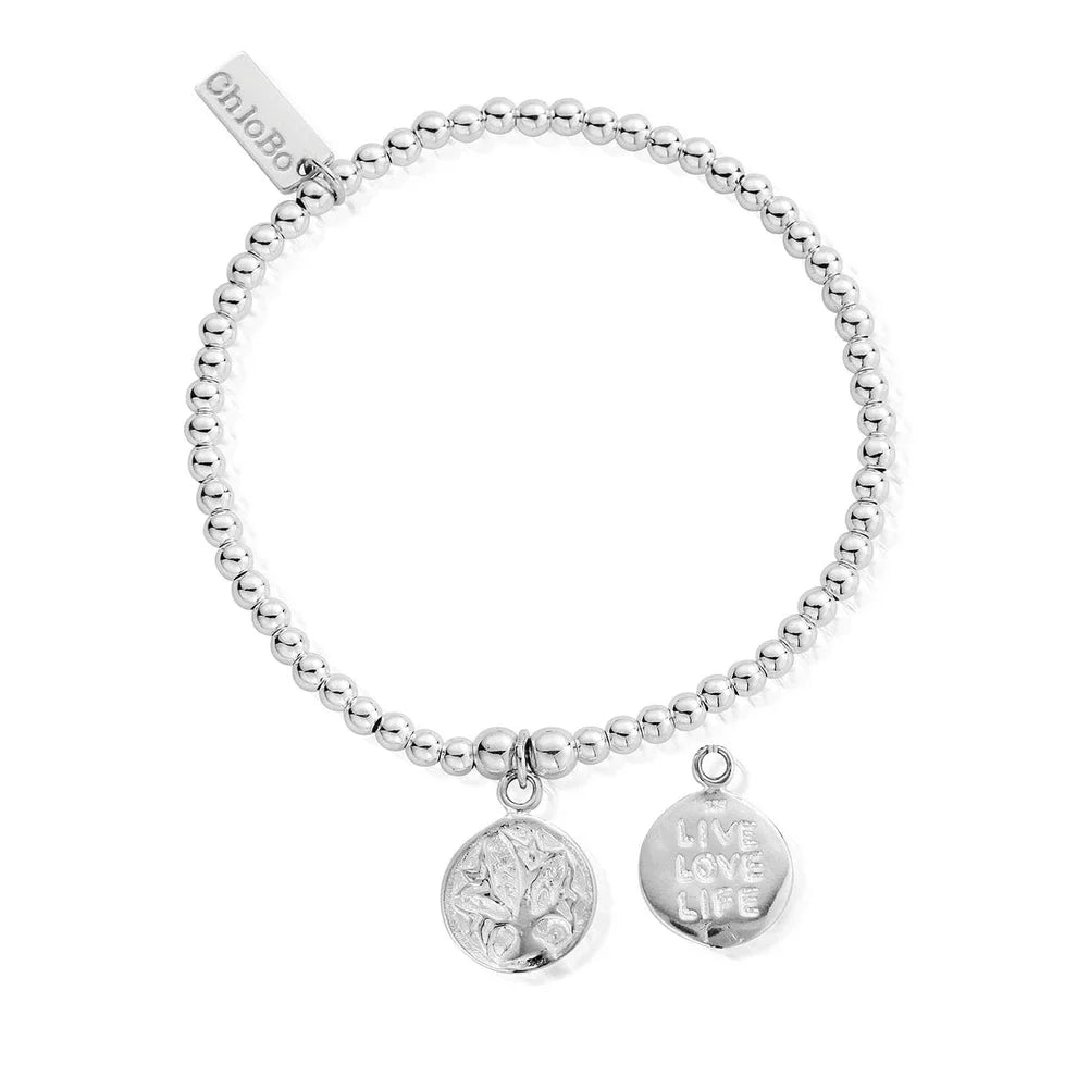Silver beaded bracelet with two circular pendants. One pendant has a tree design, the other says "Live Love Life."
