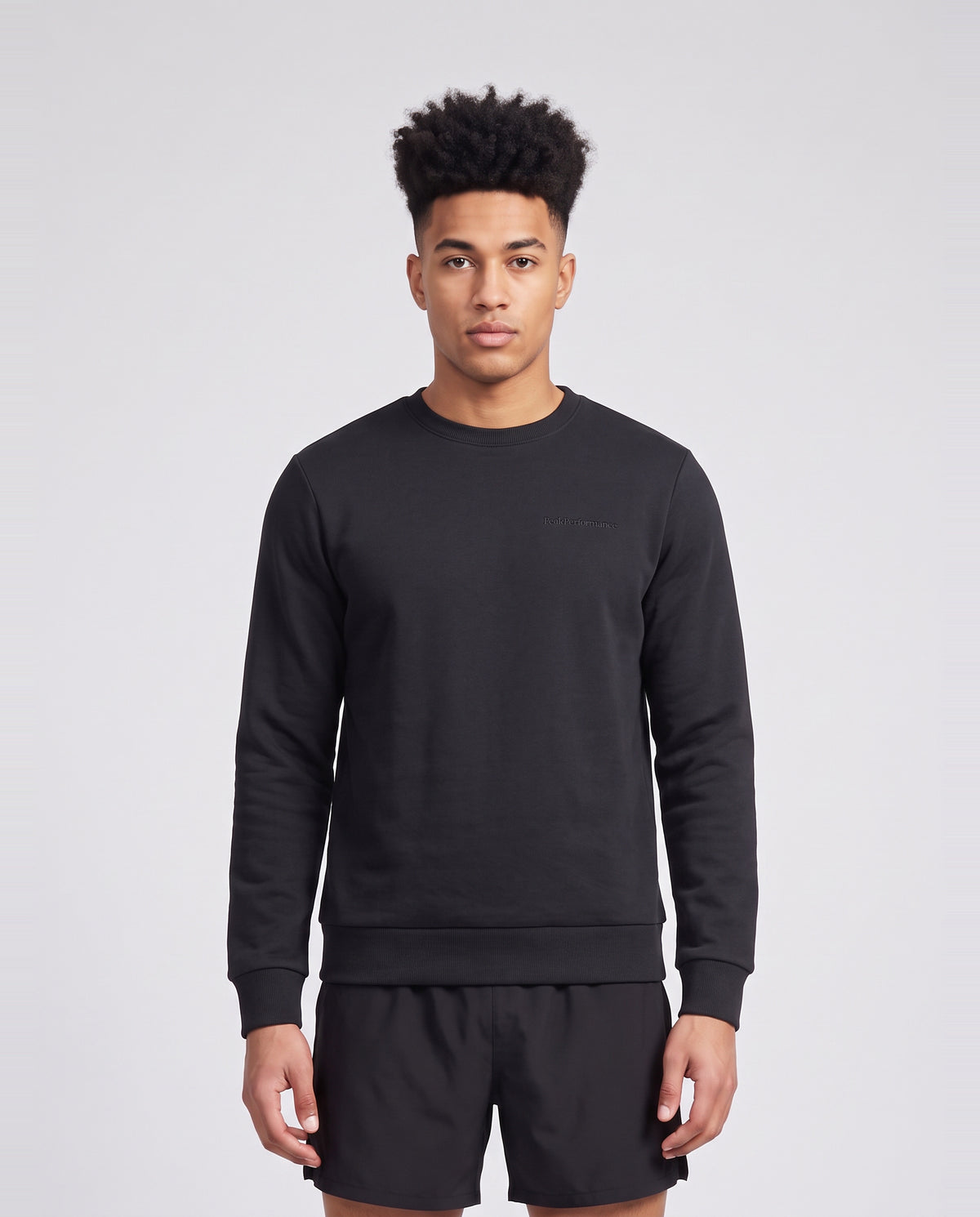 Men's Peak Performance Original Small Logo Crew in Black — on model