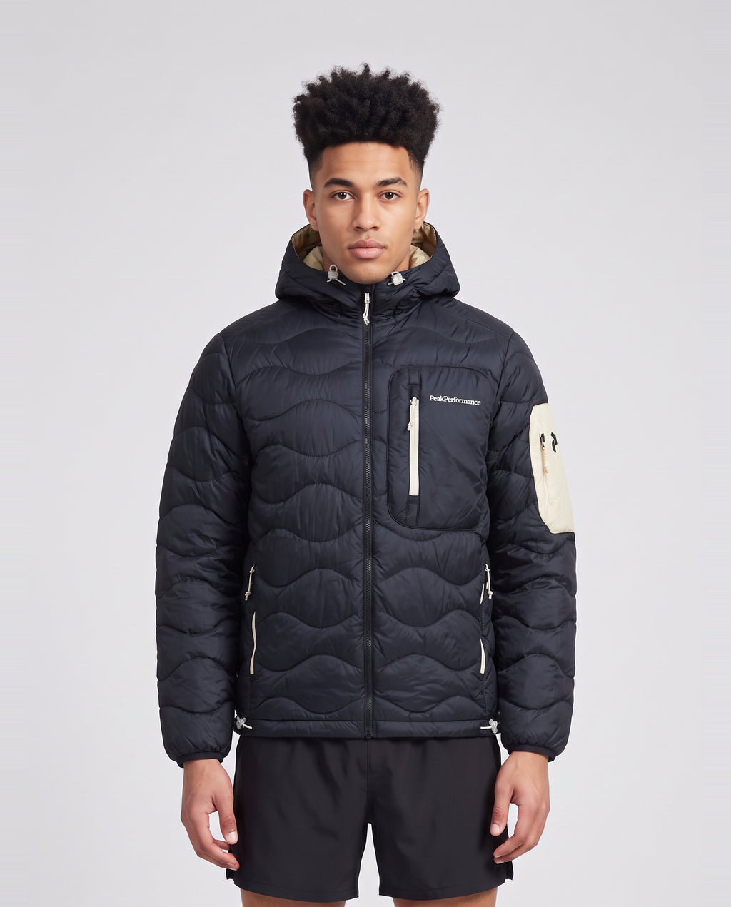 Men's Peak Performance Helium Utility Down Hood in Black/Sand Fog — on model