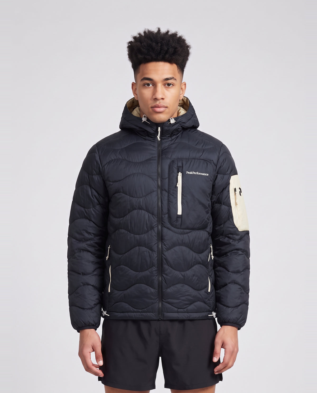 Men's Peak Performance Helium Utility Down Hood in Black/Sand Fog — on model