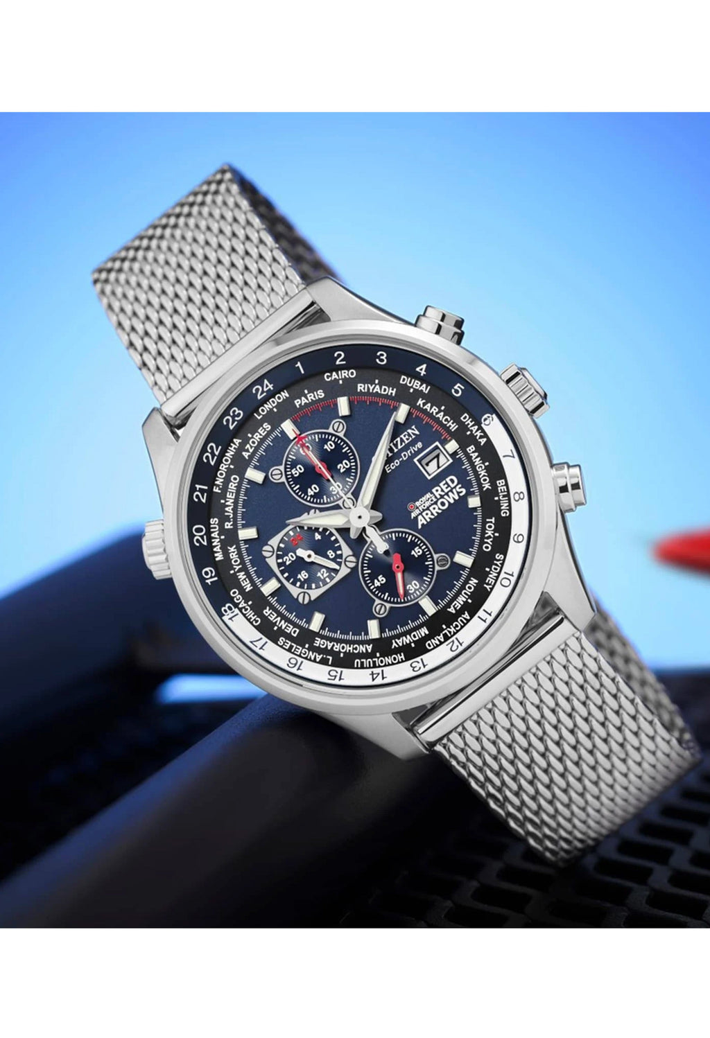 Citizen Eco-Drive watch showcasing world time functions, blue chronograph dial, and stainless steel bracelet.