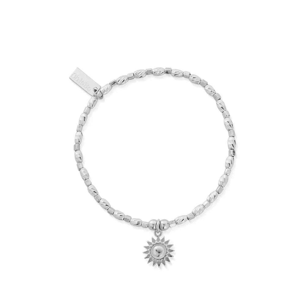Silver beaded stretch bracelet with a sun charm.
