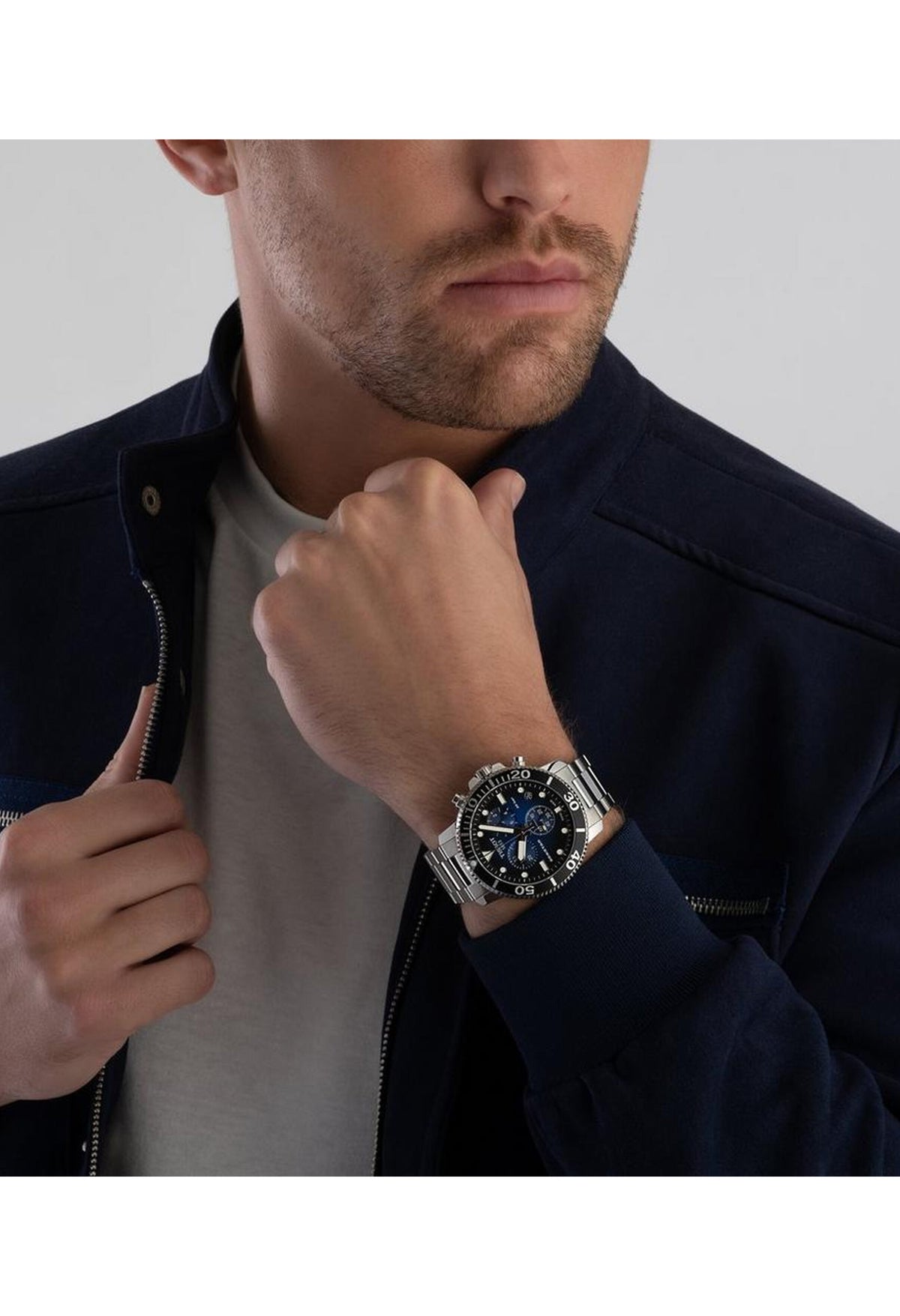 Man wearing a Tissot Seastar 1000 diver watch. Stylish chronograph wristwatch for precision timekeeping and diving.